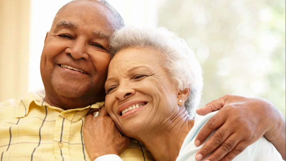 HappyOlderCouple Elderly husband and wife hugging