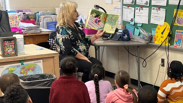Volunteer 7 copy Employee reading to classroom of children.